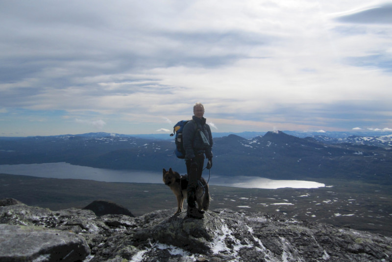 A man with a dog on the top of a mountain in Nord Saulo. Photo