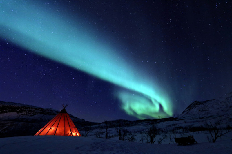 Northern lights above a tipi. Photo