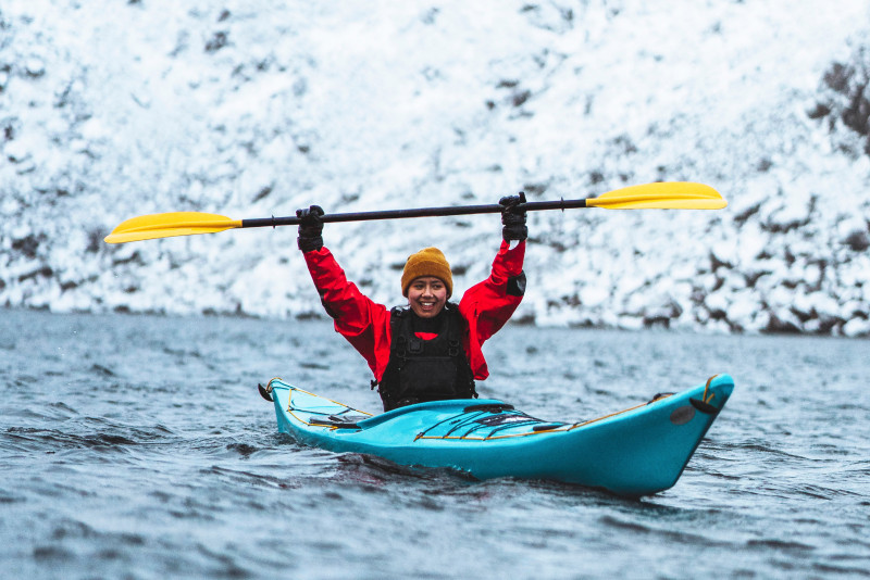 Woman padling kayak in winterseason. Photo